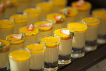 Tasty fruit dessert cups with strawberries on top