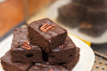 Brownies stacked with walnuts on top