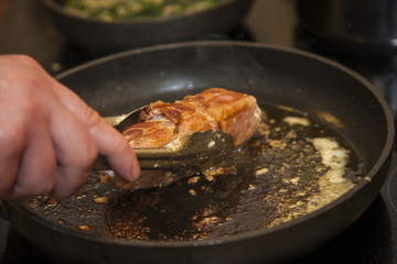 Cook frying meat in pan