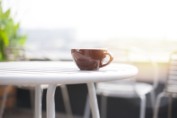 Morning coffee cup on wooden table in sunshine day with river background