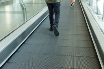 Obraz premium Two people walking in an escalator