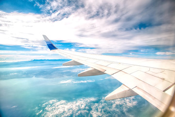 Looking through window aircraft during flight in wing with a nice blue sky