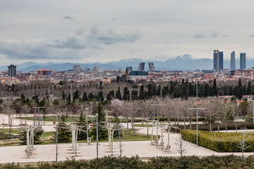 Skyline of Madrid with skyscrapers the four towers and snowy mountains in the background