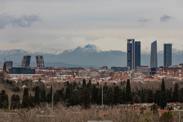 Skyline of Madrid with skyscrapers the four towers and snowy mountains in the background