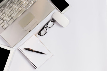 Office desk table with laptop,smartphone and coffee cup notepad and accessories. Top view