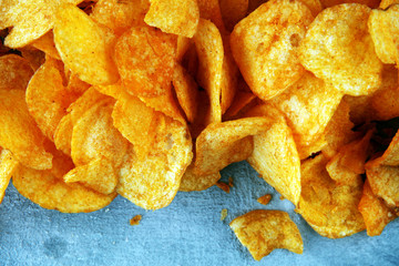 Crispy potato chips. Paprika chips on table. Spicy crunchy chips