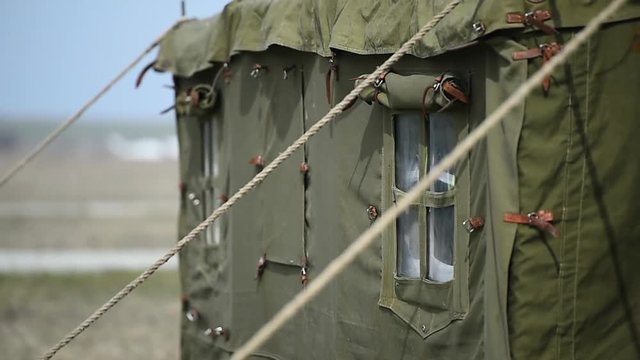 Closeup video with a green military tent