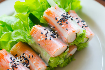 Fresh vegetable salad roll with crab stick eating with spicy salad dressing © Lion1st