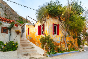 Beautiful cosy narrow street with stairs in famous Placa district, Old Town of Athens, Greece