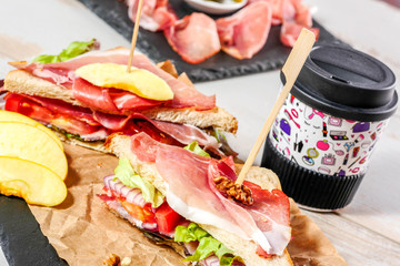 sandwiches with salad, tomatoes, ham and onions