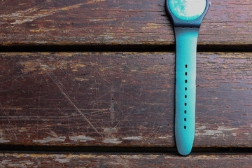 A colorful watch on the wooden table 