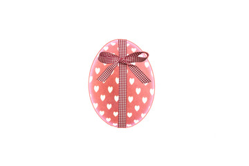 pink easter egg with white hearts and checkered bow