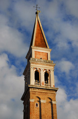 Fototapeta na wymiar Saint Francis of the Vineyard Church renaissance bell tower among clouds in Venice, built in the 16th century by venetian architect Ongarin