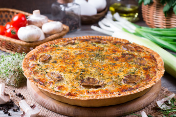 Pie with mushrooms, chicken on wooden kitchen board
