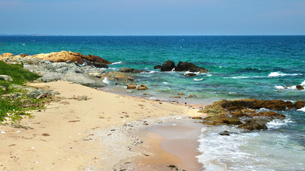 turquoise water and rocks at beach in Mui Ne, Vietnam
