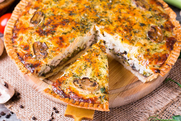 Pie with mushrooms, chicken on wooden kitchen board