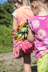 Little Girl Holding Fresh Picked Sunflowers - 196373940