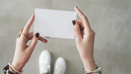 Woman finger  both hand holding white card