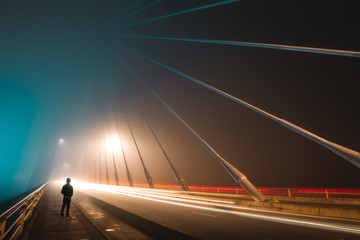 Long exposure in foggy night on iron bridge