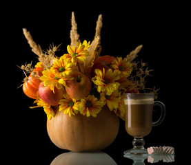 Original bouquet in pumpkin, cup of cappuccino and marshmallows, isolated on black