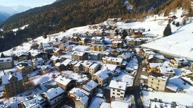Aerial view of Italian Alps in snowy winter - Oga village, Bormio, Italy from above, 4k UHD