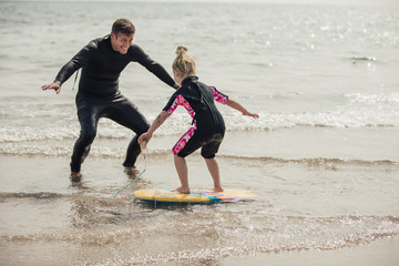 Teaching a Little Girl how to Surf