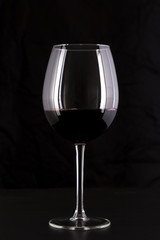 Red Wine Glass in a Black Background