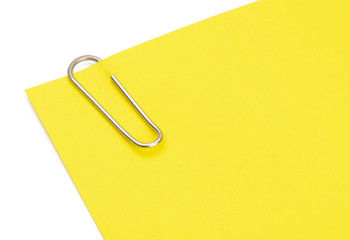 Yellow paper clip on white background
