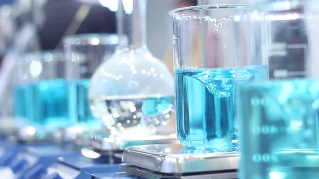 Scientist mixing chemicals in erlenmeyer flask