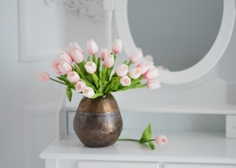 artificial tulips on a table with a mirror