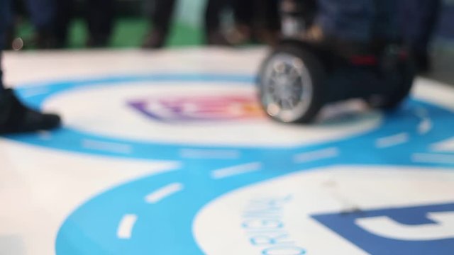 People ride on modern modernized segway in a shopping center