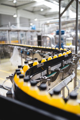 Industrial factory indoors and machinery. Robotic factory line for processing and bottling of soda...