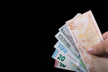Hand holding American dollar  isolated on black background