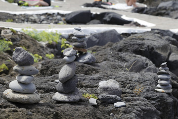 Several pebbles stacked up in a beach