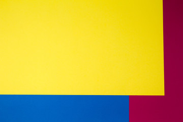 Color papers geometry flat composition background with yellow, red and blue tones