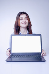 Naklejka premium Happy young woman showing laptop screen. Free place for text of designer.