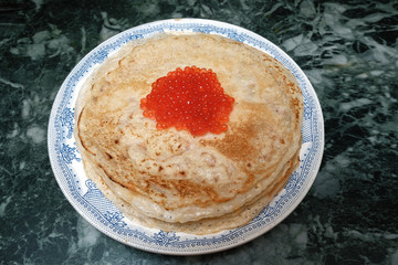 pancakes on a plate with red caviar