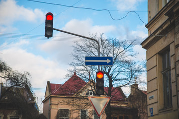 red traffic light at city street blue sky with clouds on background