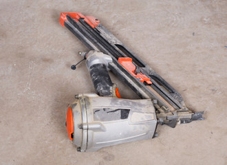Pneumatic collated framing nailer in the basement of house under remodeling