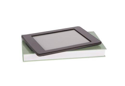 Ebook reader tablet with blank screen and a paper book. Isolated on white.