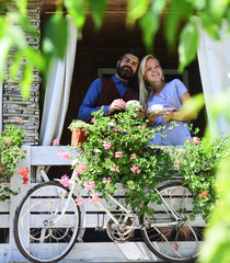 Retro tandem bicycle near red flowers