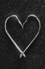 Love for fishing concept: Fishing hooks on a heart shape.
