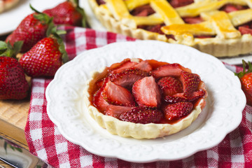 The strawberry pie in the wooden background