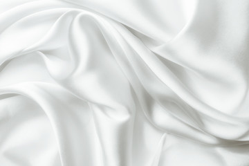 Fototapeta na wymiar Elegant white satin silk with waves, abstract background.