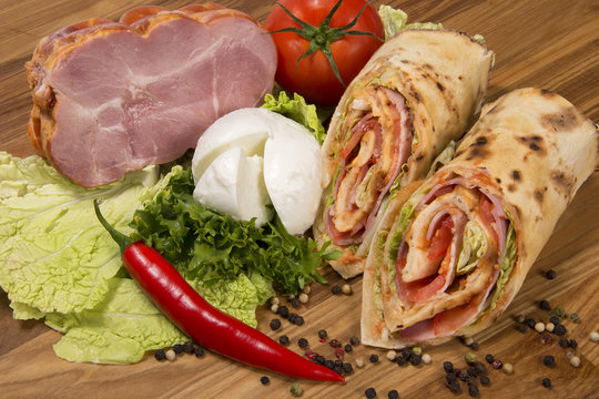 Wrap sandwich with ham, tomato  and mozzarella 