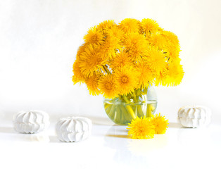 Bouquet of spring flowers. Still life of dandelions and marshmallows. Isolated on white background.