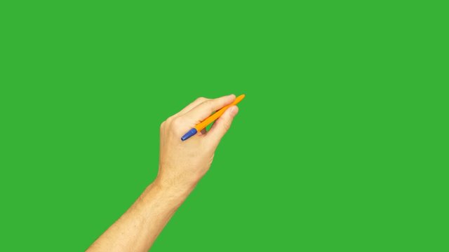 Male left hand holding pen for writing on green background. Alpha channel, keyed green screen.