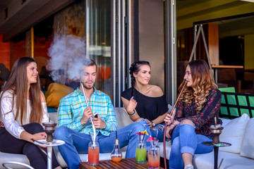 Frends hanging out and smooking hookah