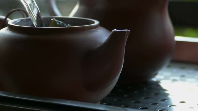 Pouring tea in tea ceremony close up
