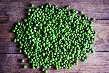 green peas on a old wooden surface